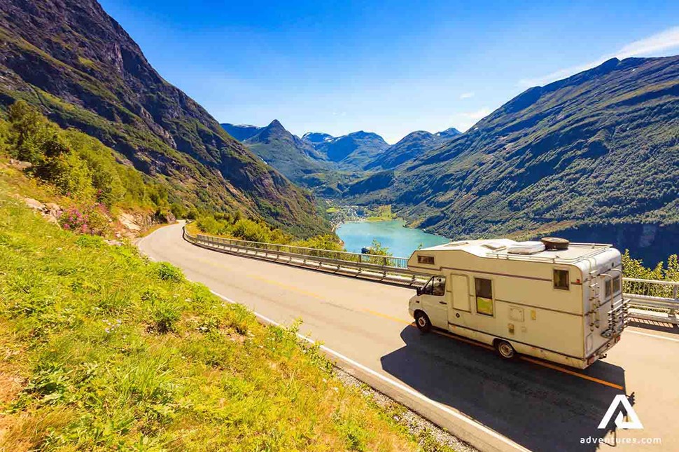 campervan driving on a road between fjords in norway