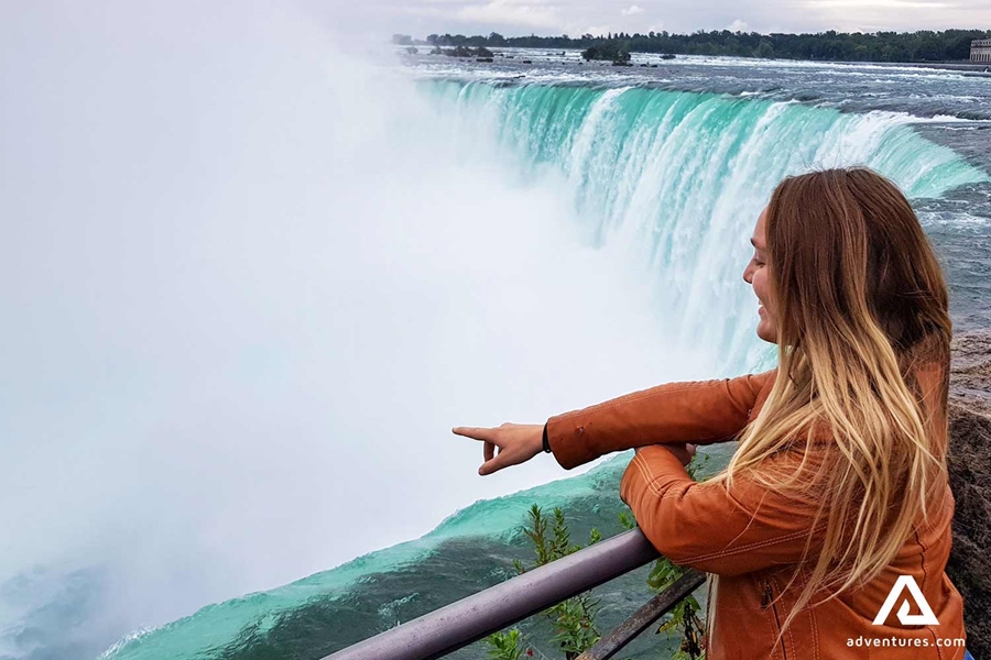 Woman Pointing At Niagara Falls
