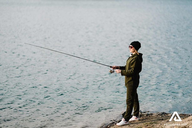 woman fly fishing in summer
