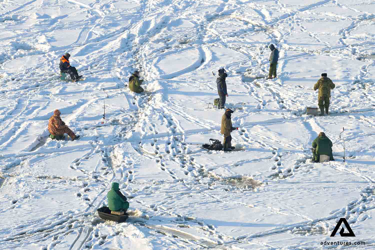 group of fishers on icy lake