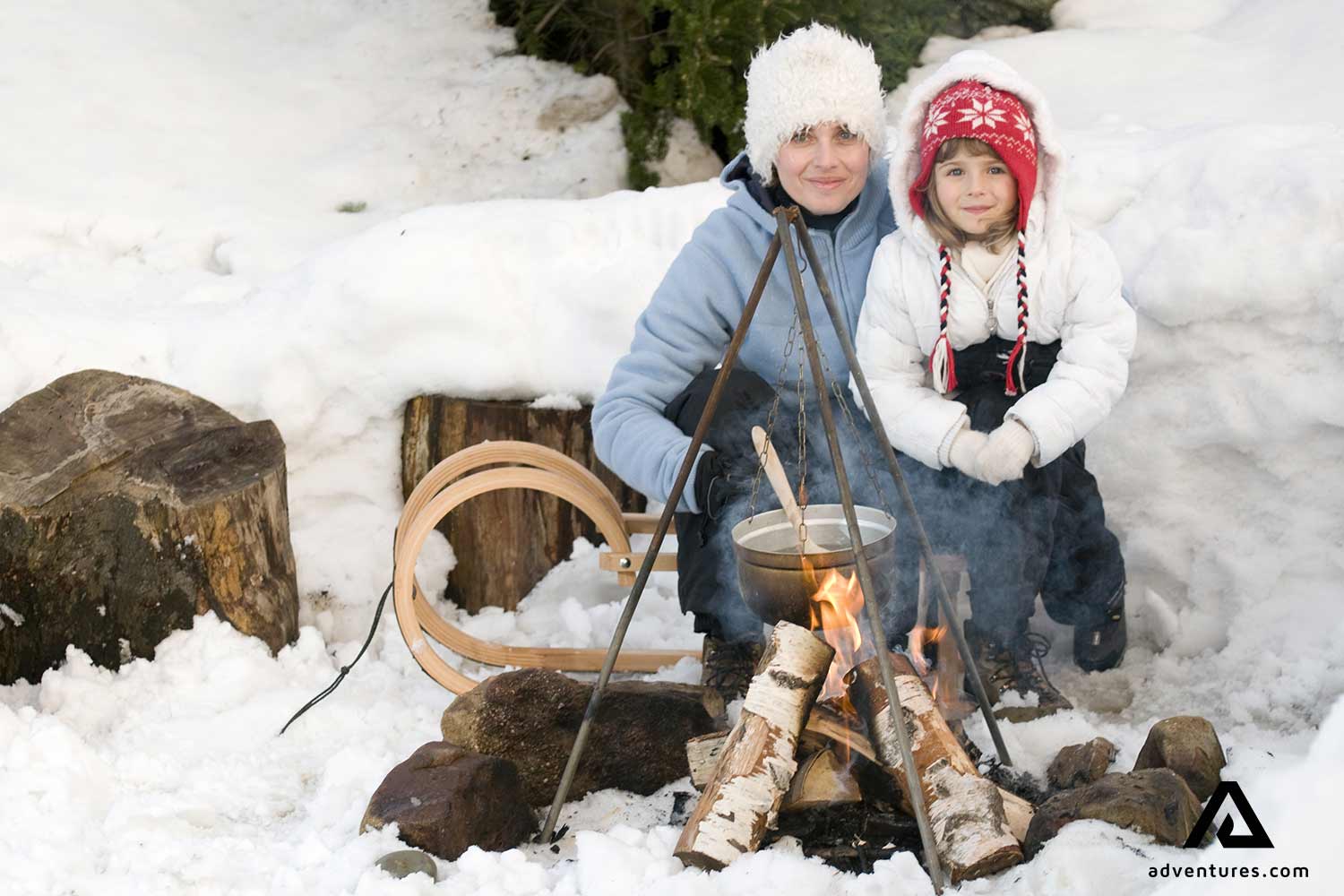 mother and daughter cooking food in winter