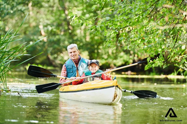 father and son canoeing in finland