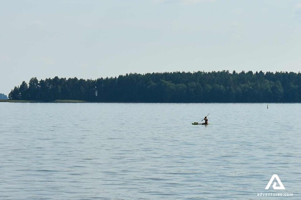solo paddle boarding in finland near a forest