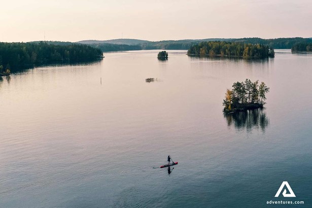 aerial view of paddle boarder at sunset