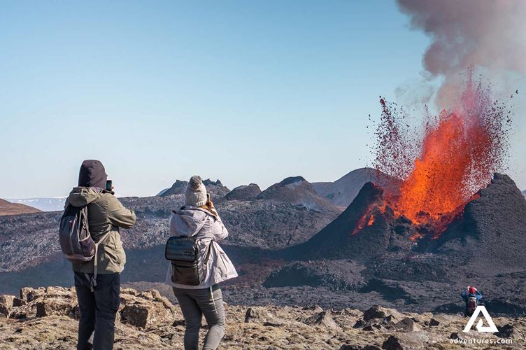 hikers taking pictures hikers taking pictures of a volcano