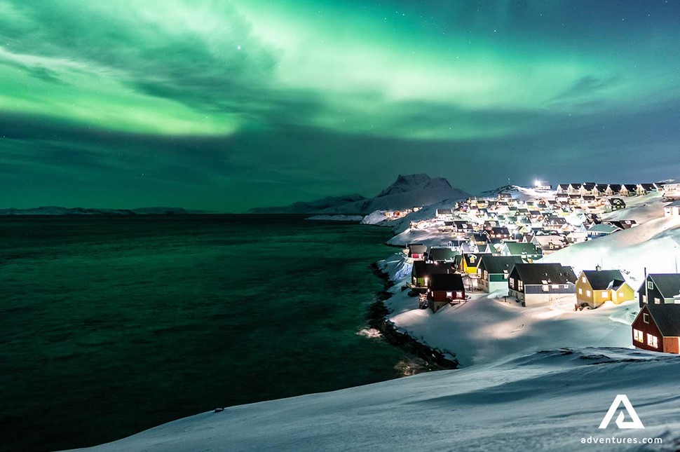 northern lights in the night city in winter