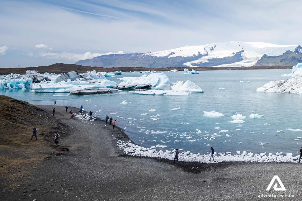 group of people hiking  in jokulsarlon glacier lagoon