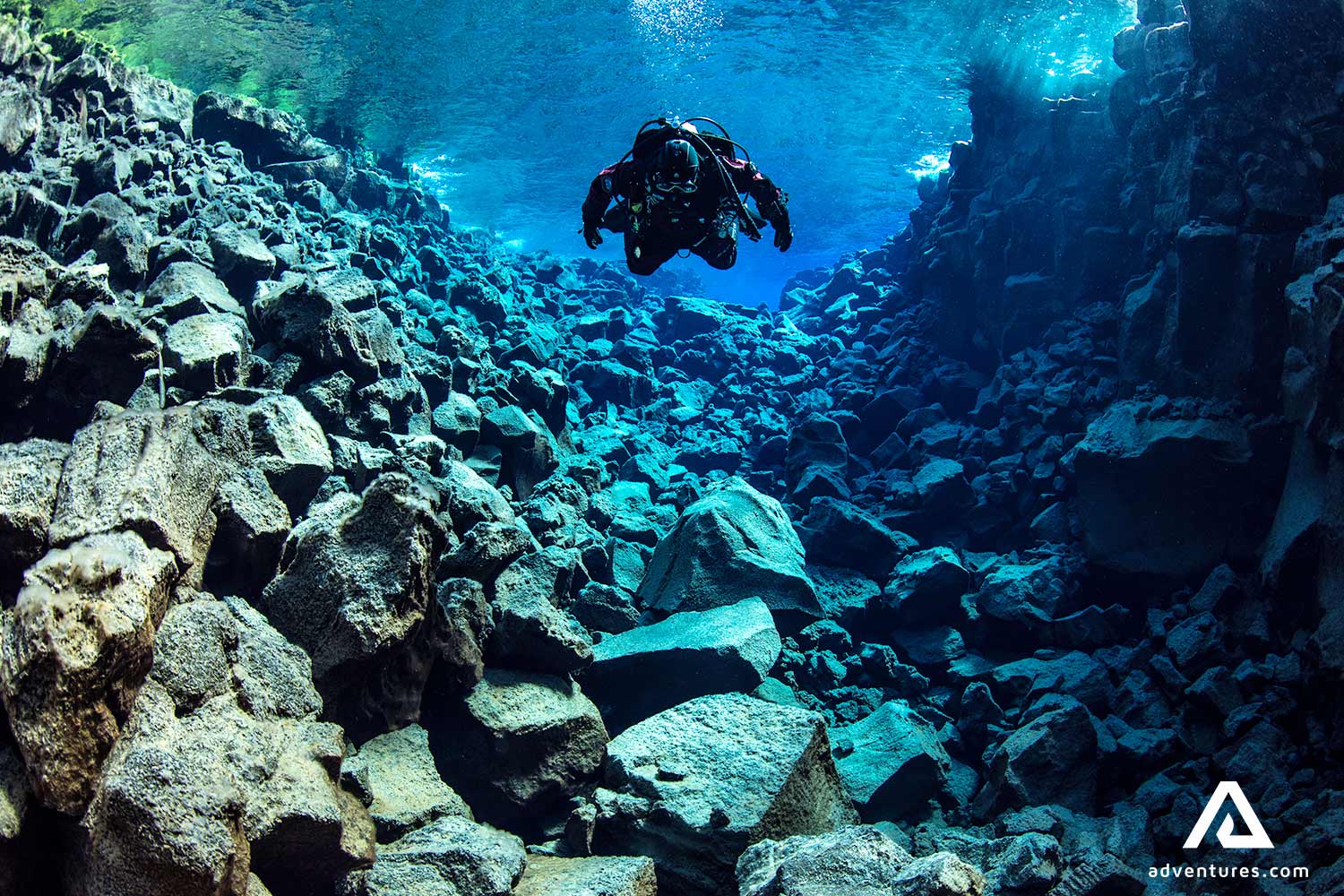 a person diving in Davidsgja  in iceland 