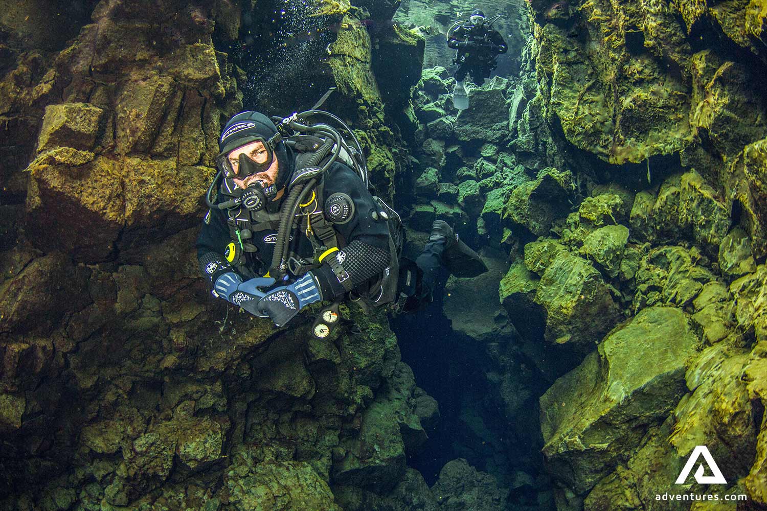 a man deep diving is silfra fissure 
