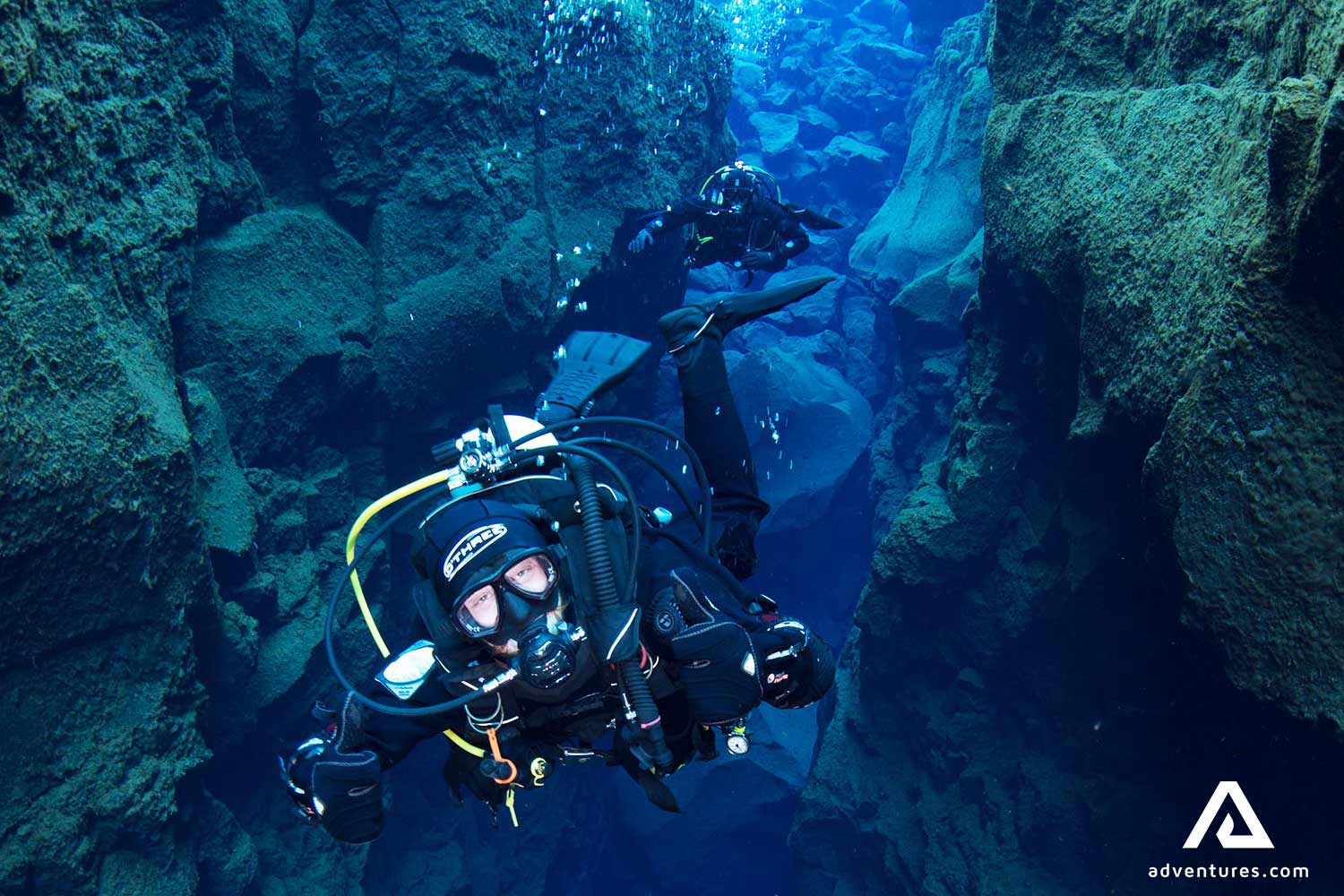person diving in silfra fissure at thingvellir national park