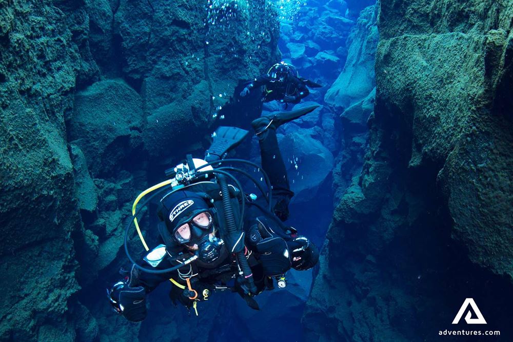 person diving in silfra fissure