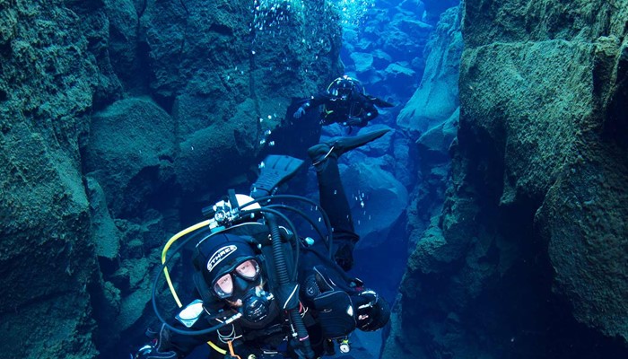 a person diving between two tectonic plates in iceland