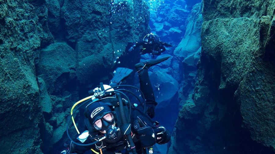 a person diving between two tectonic plates