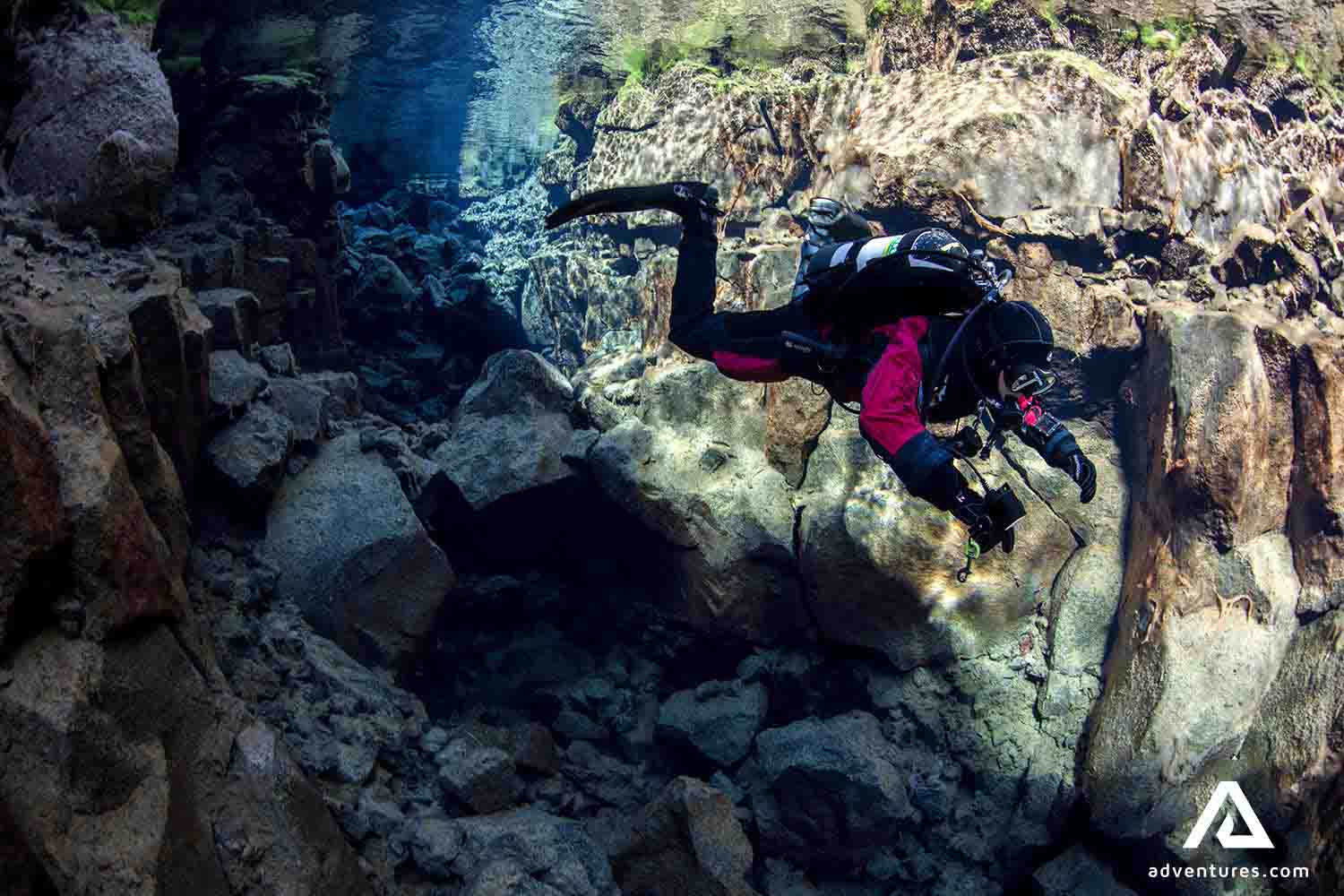a man solo diving in silfra fissure