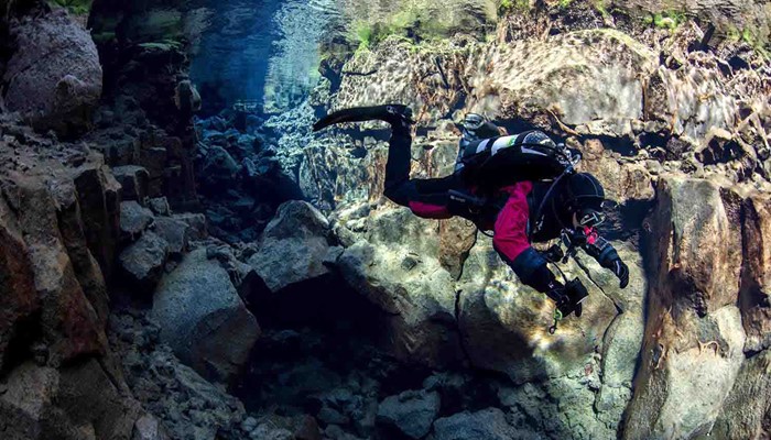 a man solo diving in silfra fissure