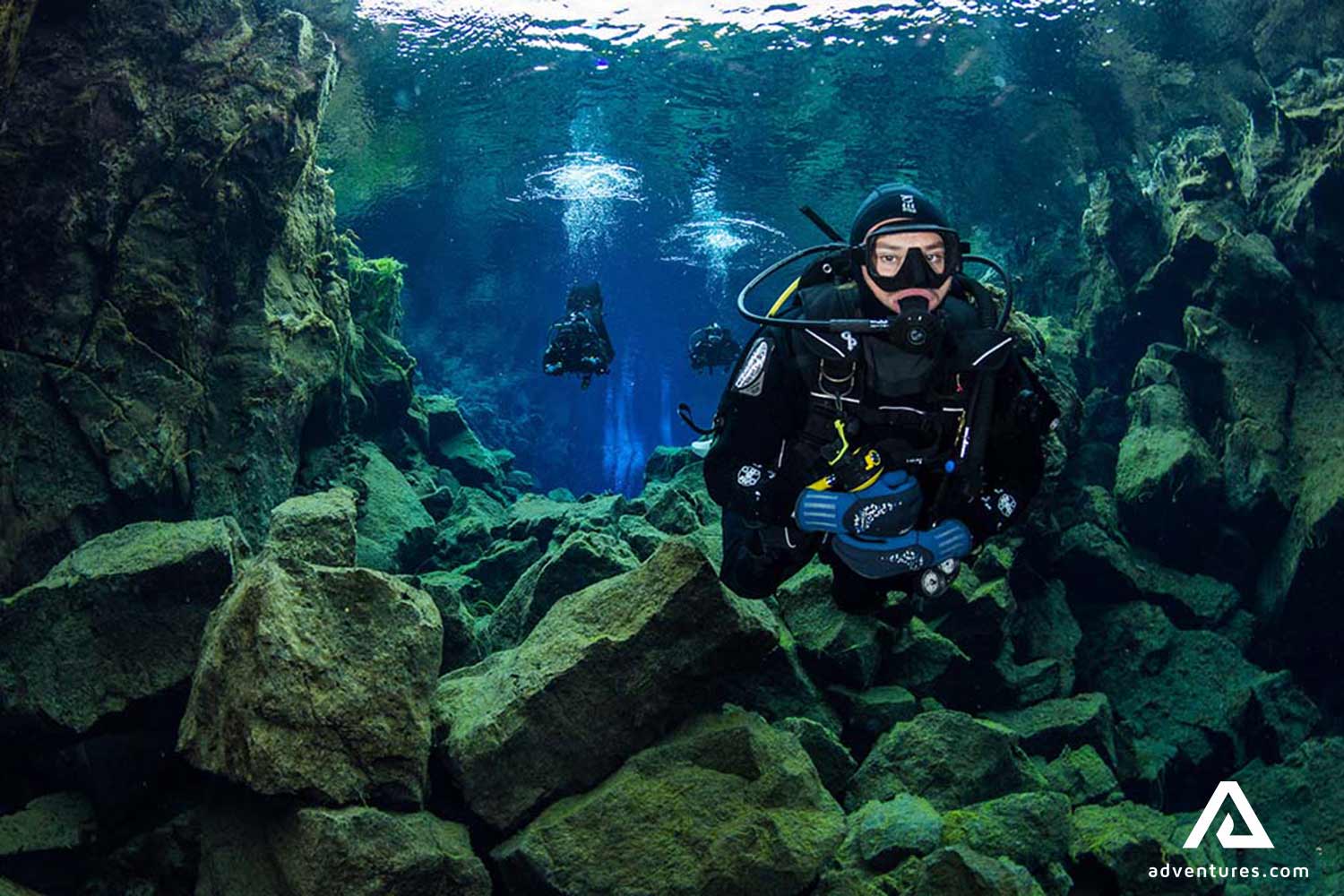 three people scuba diving