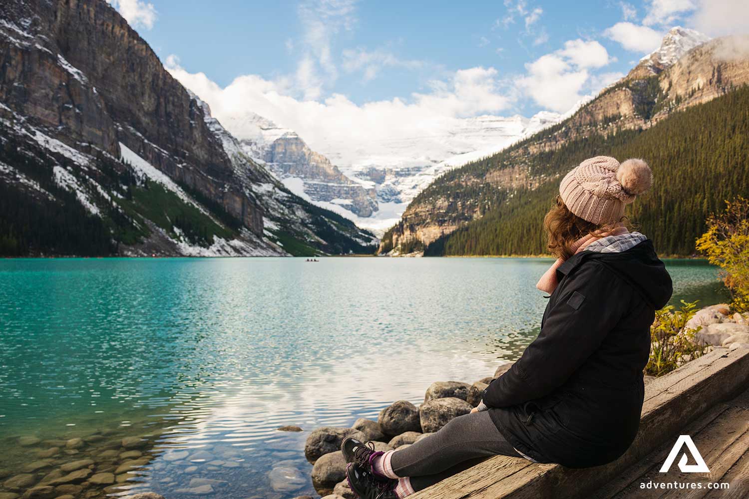 woman sitting resting near lake louise in canada