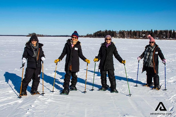 group of four people snowshoeing in canada