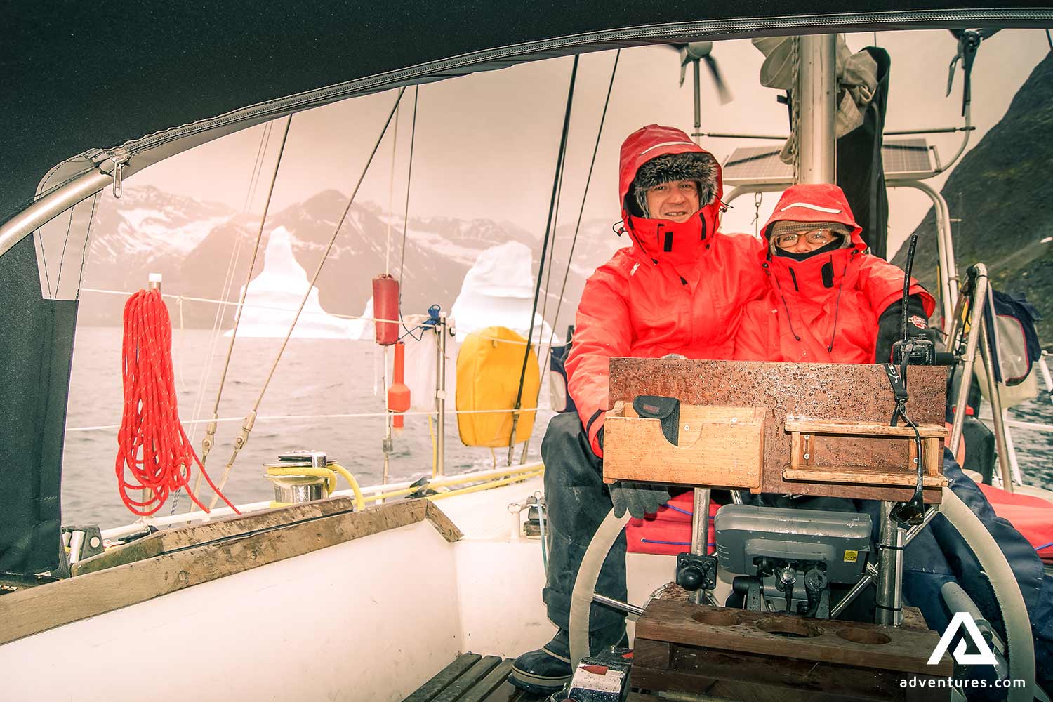 father and son sailing boat in greenland