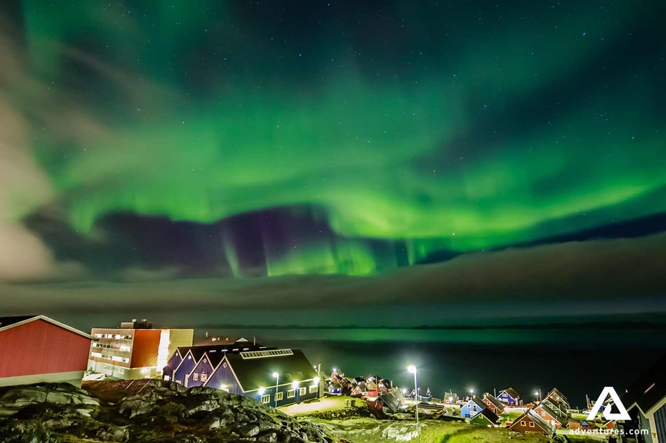 nuuk city buildings and northern lights 