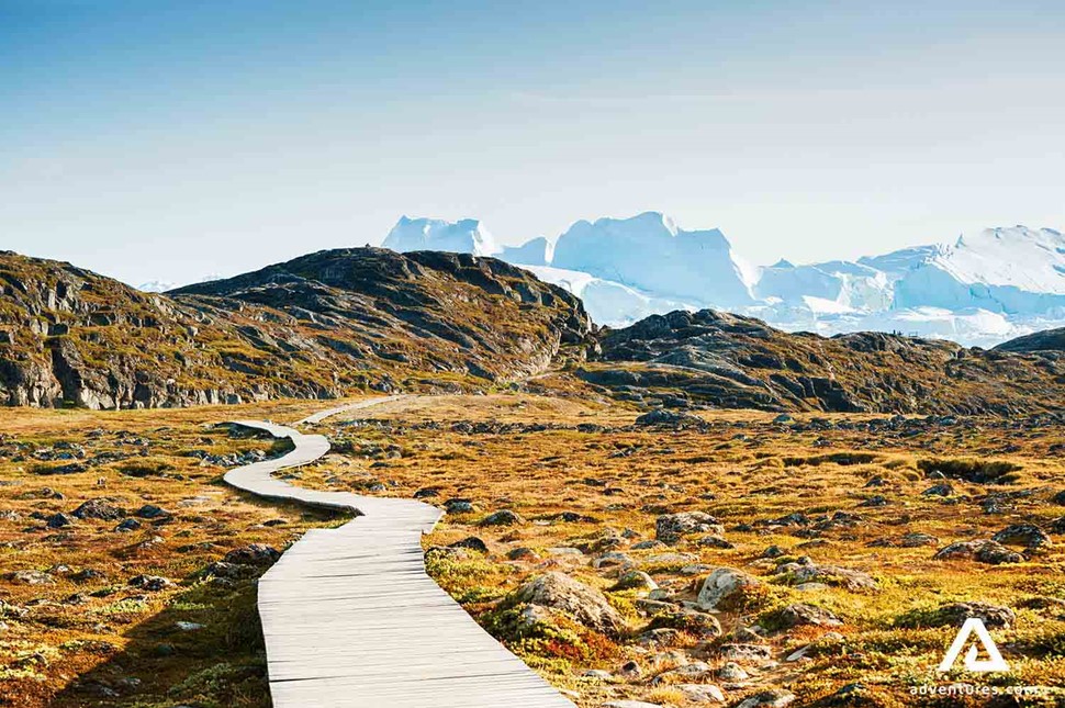 sunny wooden hiking path in greenland