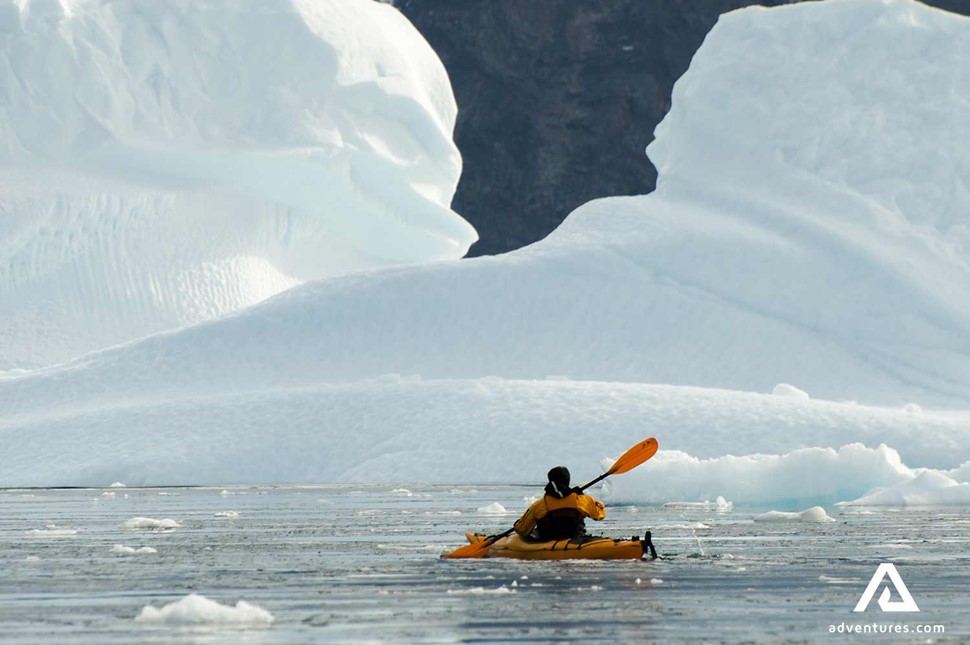 solo kayaking around icebergs in greenland