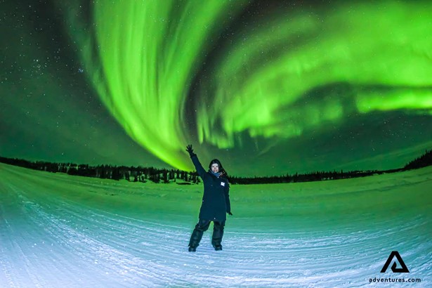 woman posing in front of aurora borealis