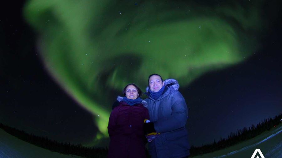 happy couple and the northern lights