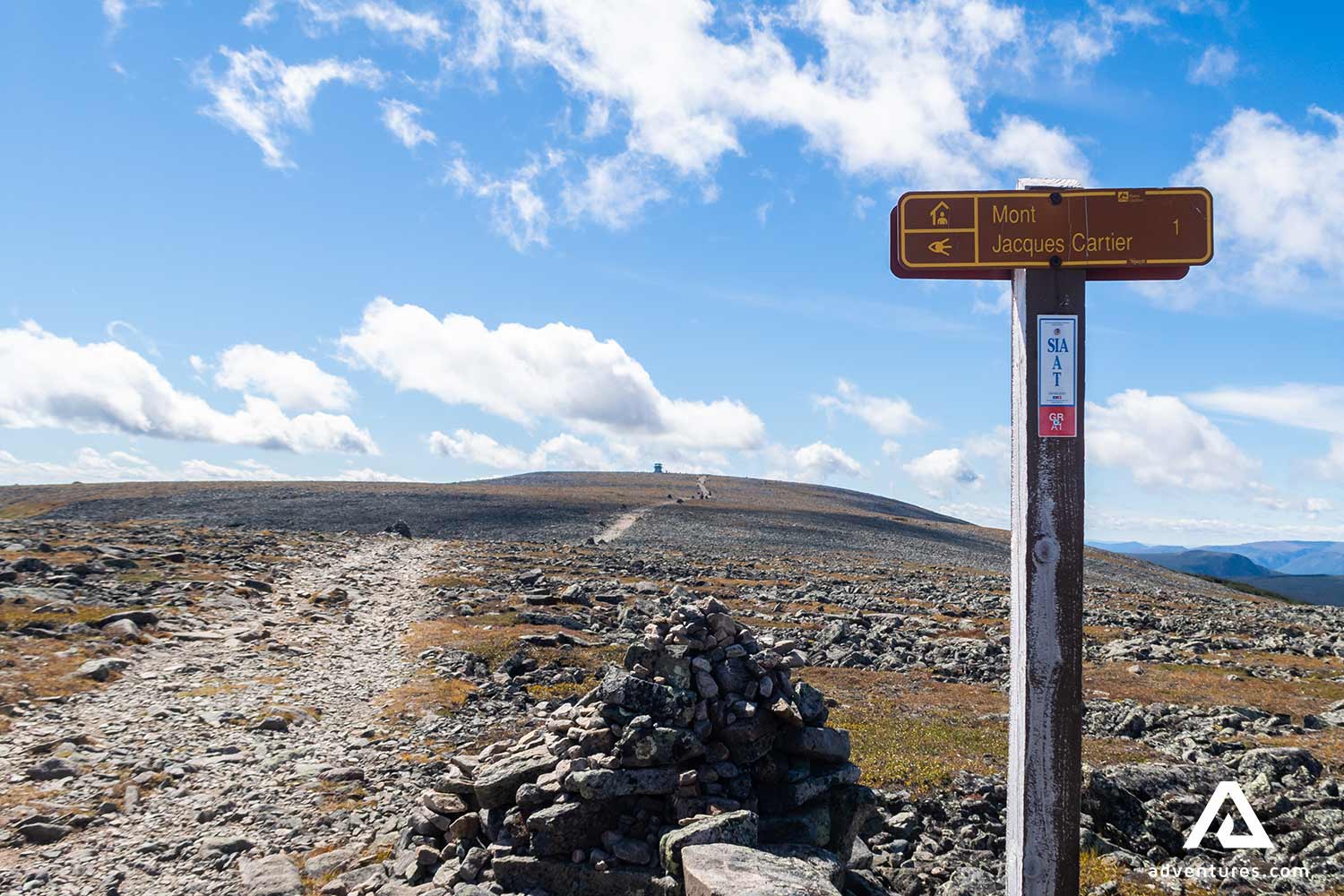 hiking path sign near mont jacquest cartier mountains in canada
