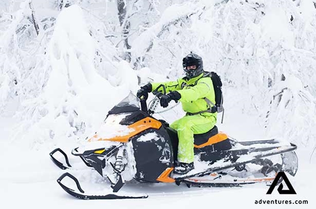 man solo snowmobiling in finland 
