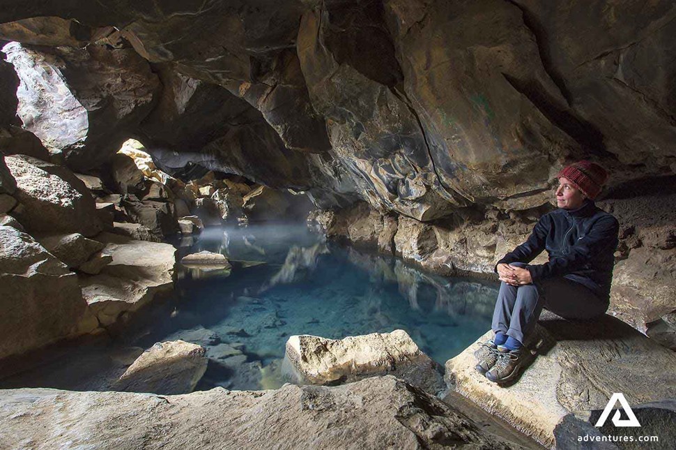 woman relaxing in grjotagja geothermal cave 
