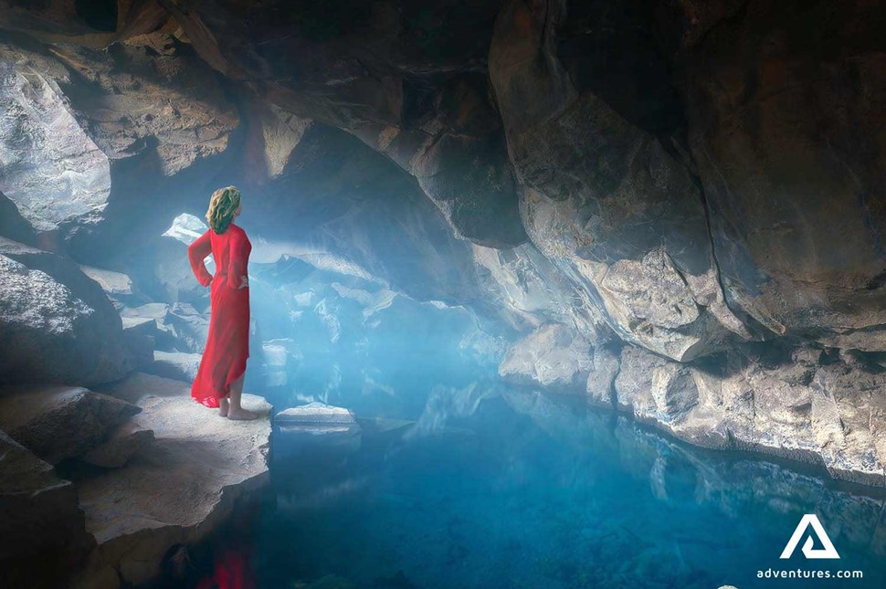 woman in myvatn grjotagja geothermal cave 