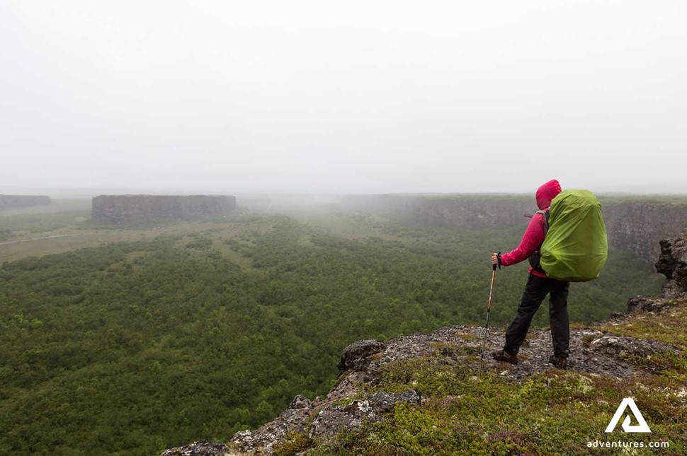 person with a backpack at asbyrgi canyon