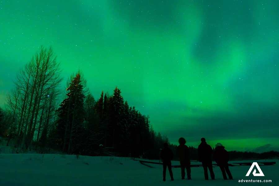 friends watching northern lights in finland