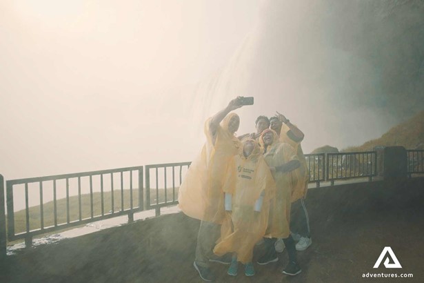 group of friends taking a selfie with Niagara Falls