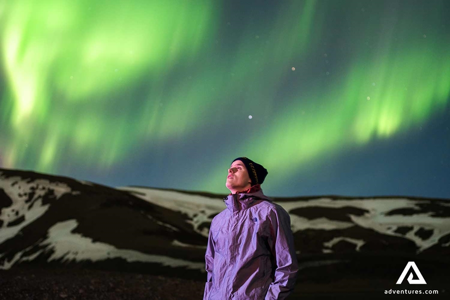 man watching northern lights at langjokull