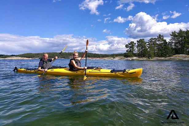 couple kayaking in summer in sweden
