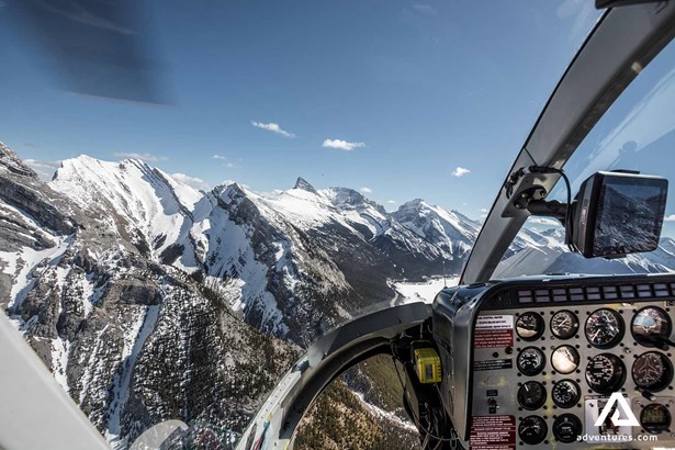 snowy mountain view from helicopter in canada