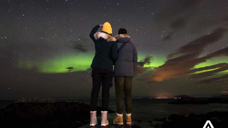 friends watching northern lights in norway