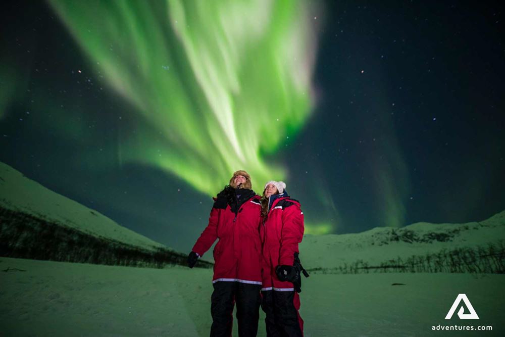 couple watching northern lights in tromso