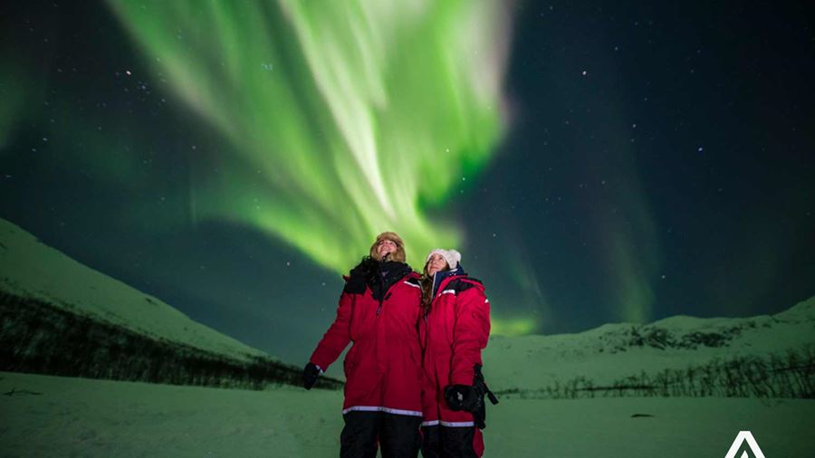 couple watching northern lights in tromso