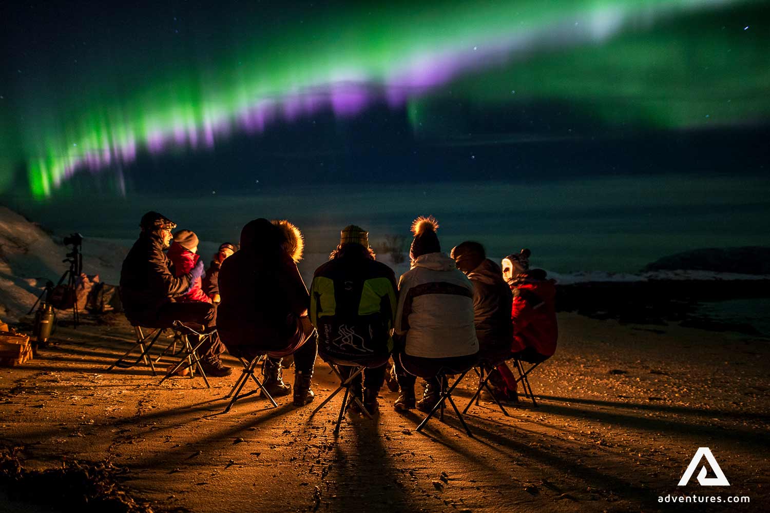 people watching bright northern lights in tromso in norway