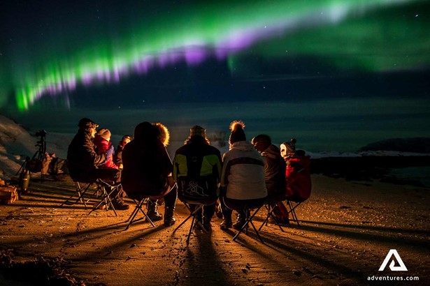 people watching bright northern lights in tromso in norway