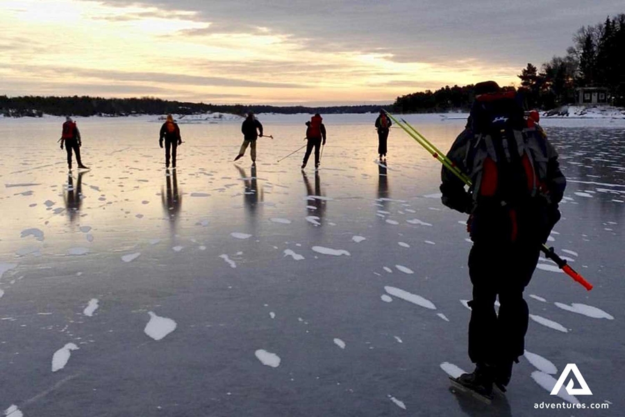 people ice skating on a lake