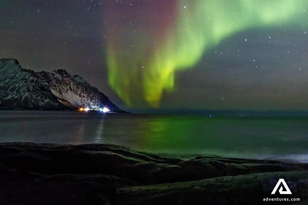 sea shore view with northern lights in lofoten