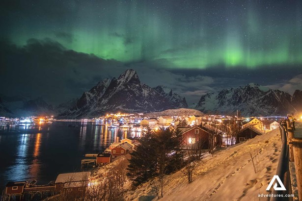 town at night surrounded by aurora in lofoten