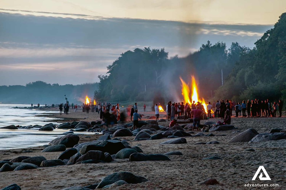 group of people at a beach celebrating midsummer in estonia