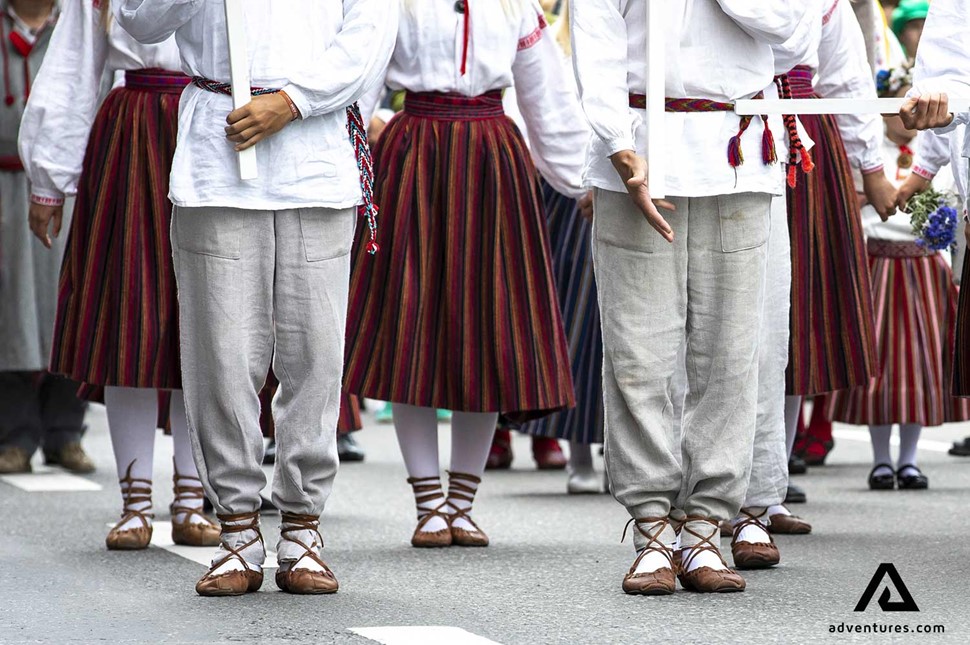 men and women dressed up in estonian national clothes at a festival