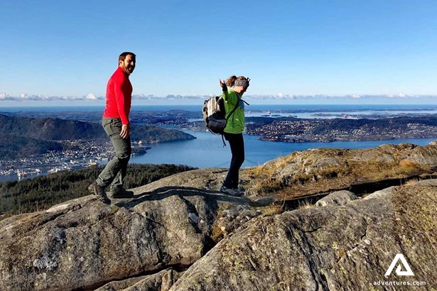 couple hiking on the mountains in bergen