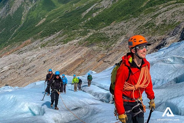 people climbing on svartisen glacier with guide